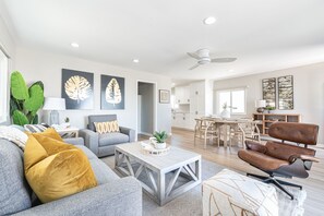 The open floor plan between dining, living, and kitchen areas allows for easy group hangouts after a day at the beach.
                