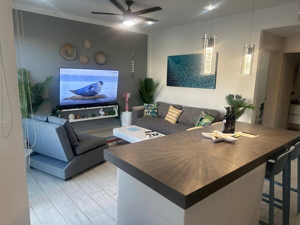 A bright and airy sitting area with a wall-mounted Smart TV