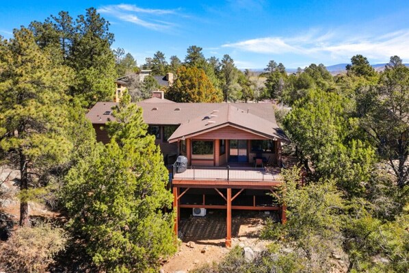 Back of the property surrounded by trees