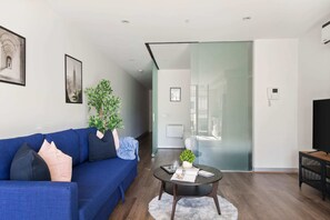 A spacious living with a 3-seater sofa.