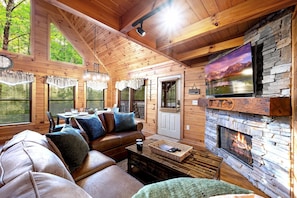 Enjoy the view of the forest from the cozy couches in the Living room. 