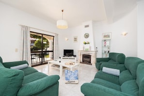 Living room with sofas, dining area, ornamental fireplace, WiFi internet, and satellite TV