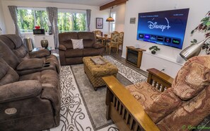 Living area with reclining couches and 65 inch TV.  Many streaming services.