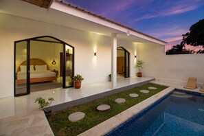 The sunset sky gracefully envelops our charming villa, painting a mesmerizing canvas of vibrant hues