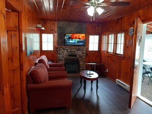 Closer view of the living room with fireplace and TV.