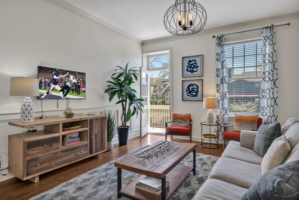2nd Floor: Warm and inviting living room featuring a Smart TV for entertainment, with a shared balcony and designer furnishing / decor.