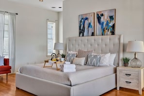3rd Floor: Primary Bedroom featuring a lavish King Bed with a Smart TV for entertainment, a wet bar for a quick refreshment and entrance to your private rooftop patio.