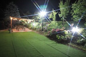 At night, the garden is lit up with lights.