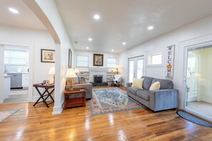 The Spanish Revival Architecture is Showcased by the Hardwood flooring, Fireplace (Decorative Only), and Hand-Painted Stucco Wall