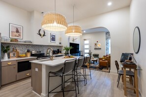 Fully equipped kitchen with an island counter and barstool seating.