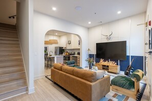 Living room features seating and a TV.