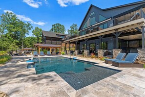 Blue Heron pool with sport depth, volleyball net and plenty of seating options. 