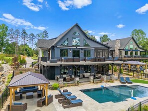 Back of Blue Heron- pool with slide, hot tub, pergola and dock. 
