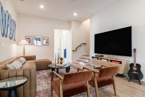 Main living area features ample seating and a flat-screen TV.