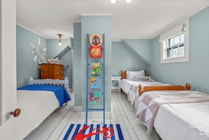 Three comfortable Twin beds in bedroom #3 with room-darkening shades.