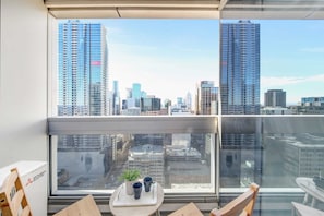 A balcony with city views. (chairs on balcony are from the dining area)