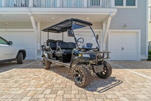 A rugged and stylish golf cart ready for adventure, perfect for cruising around the neighborhood and heading to the beach.