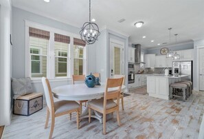 A charming dining space with large windows offering plenty of natural light.
