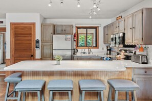 Spacious countertop and barstool seating.