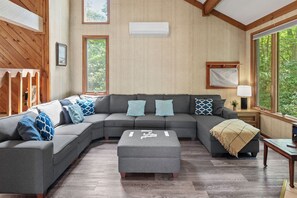 A living room with a comfy couch, and fireplace.