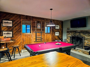 Cozy up by the fireplace and rack up some points on the pool table.