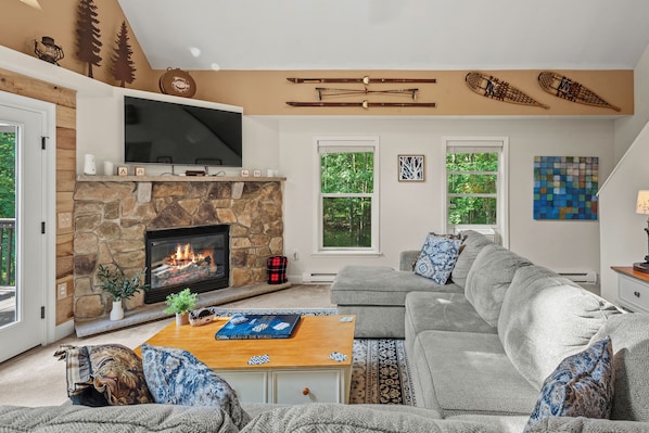 This cozy living room exudes warmth and comfort, perfect for relaxing by the fireplace.