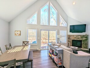 Cozy living room with fireplace and deck access.