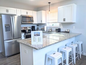 A modern kitchen with sleek countertops and stainless steel appliances.