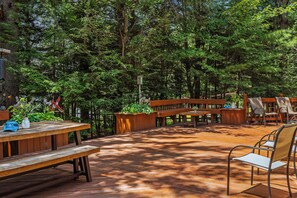 Spacious deck with outdoor seating and a BBQ grill.