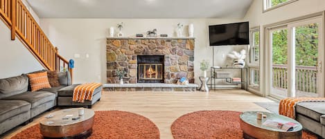 The living area features a cozy fireplace with direct access to the deck.