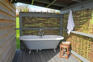 Outdoor bath overlooking the valley with distant sea views!