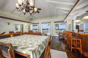 A spacious dining table that seats 8. Also, 3 bar chairs for additional seating.