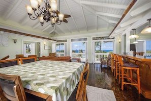 A spacious dining table that seats 8. Also, 3 bar chairs for additional seating.