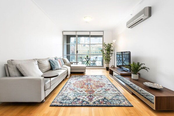 A spacious living area with a 5-seater L-shaped couch