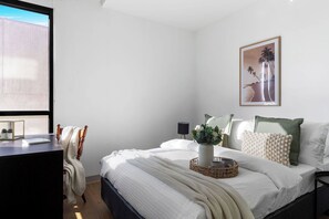 The master bedroom with a queen bed & a study.