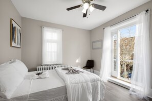 Bedroom 2 also exudes tranquility with a full-size bed, cozy linens, ceiling fan, and ample natural light.