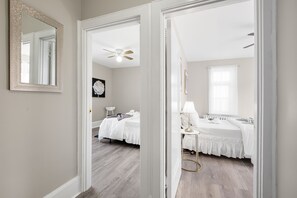 Experience two private bedrooms with full-size beds, ample closet space, natural light, private entrances, ceiling fans for ventilation, and individual air conditioning units.