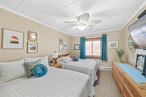 1 bedroom with two full beds, TV in bedroom, half bath in bedroom