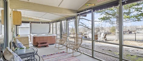 Enjoy your enclosed patio with privacy blinds offering a 6 person hot tub, comfortable seating and peaceful views.