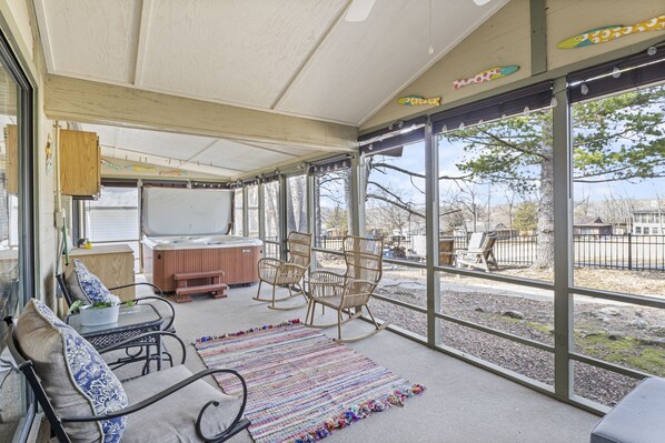 Enjoy your enclosed patio with privacy blinds offering a 6 person hot tub, comfortable seating and peaceful views.