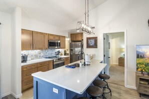 Your kitchen is fully equipped for meals in offering a spacious pantry just beyond the refrigerator.