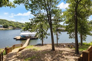 The vast lakefront is protected by  an open lot and a tree line for private enjoyment during your stay.