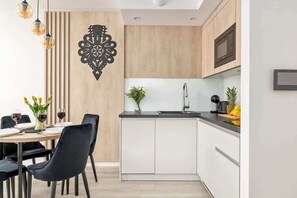 The modern dining room with its minimalist design and black chairs is conducive to shared meals.