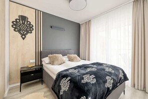 An elegant bedroom with dark bedding and gold accents is the perfect place to relax and unwind.
