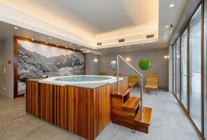 A luxurious jacuzzi with wooden elements will give you the relaxation you need after long hikes.