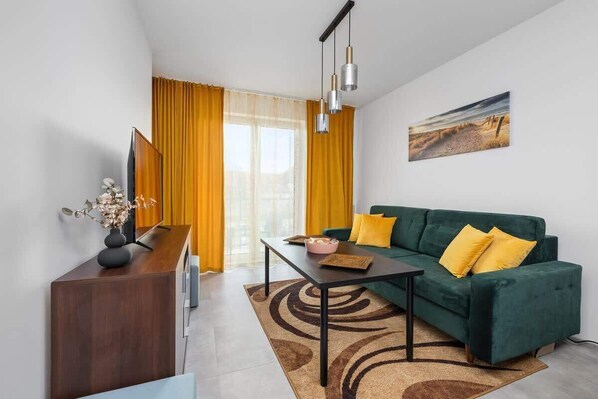 Living room with a comfortable sofa and TV. 
