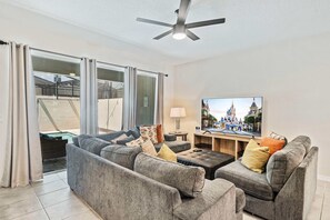 Plush Living Area of the Townhouse in Kissimmee Florida - Comfy Sofas - Easy access to outdoor with seating and Pool - Smart TV and Netflix - Elegantly decorated space with a neutral color palette for a timeless appeal