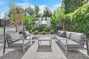 The balcony beckons with an inbuilt BBQ, mini bar fridge, spacious outdoor dining table for ten, and additional lounge area for al fresco enjoyment.