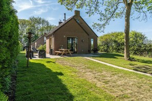Step into a backyard retreat where sunlight, green grass, and a cozy patio create the perfect space to relax, entertain, or just breathe. 