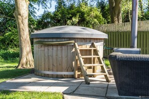 Unwind in style—this rustic wood-fired hot tub is your ticket to relaxation under the trees. Serenity, warmth, and nature in perfect harmony. 